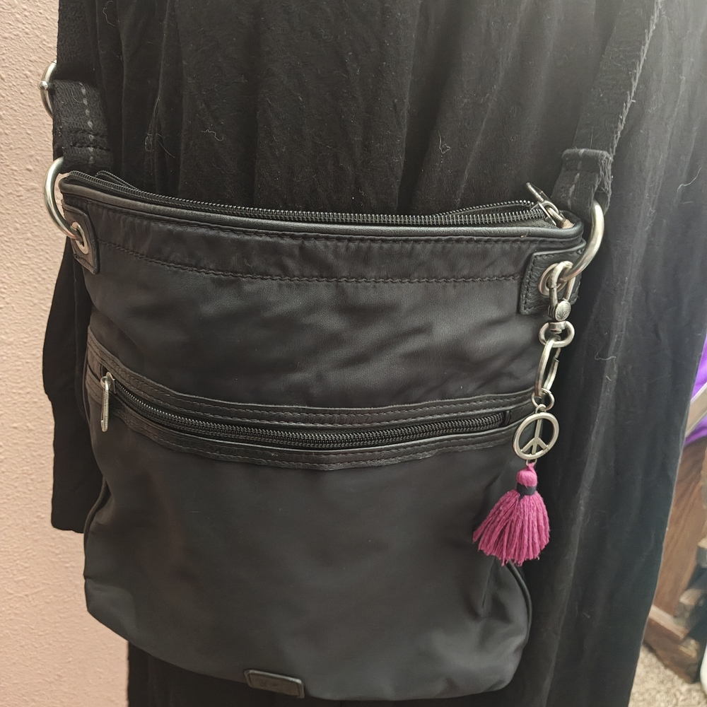 The Sak Black Crossbody Bag with Magenta Tassel